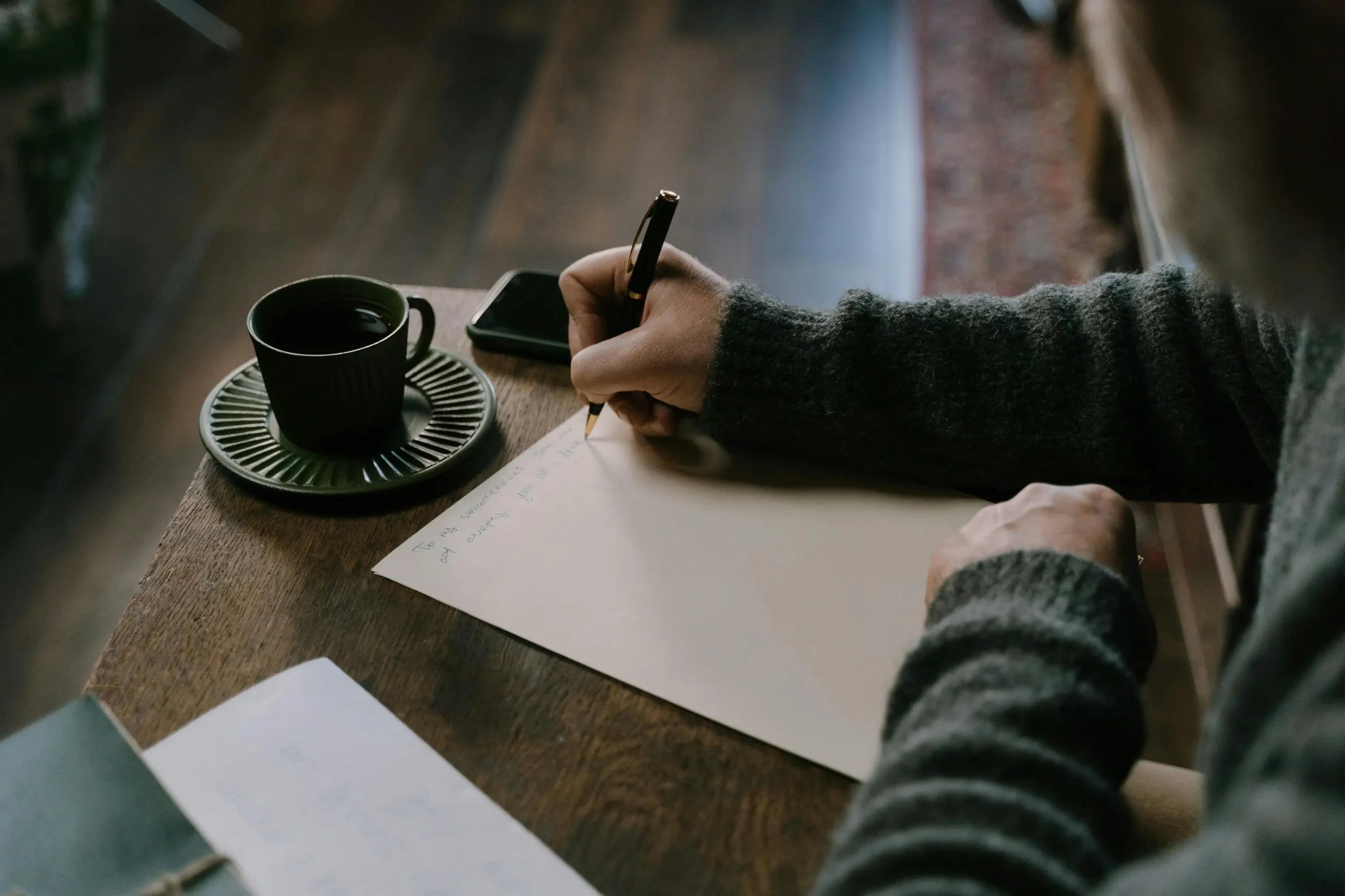 Person journaling in warm light, building emotional intelligence and self-awareness