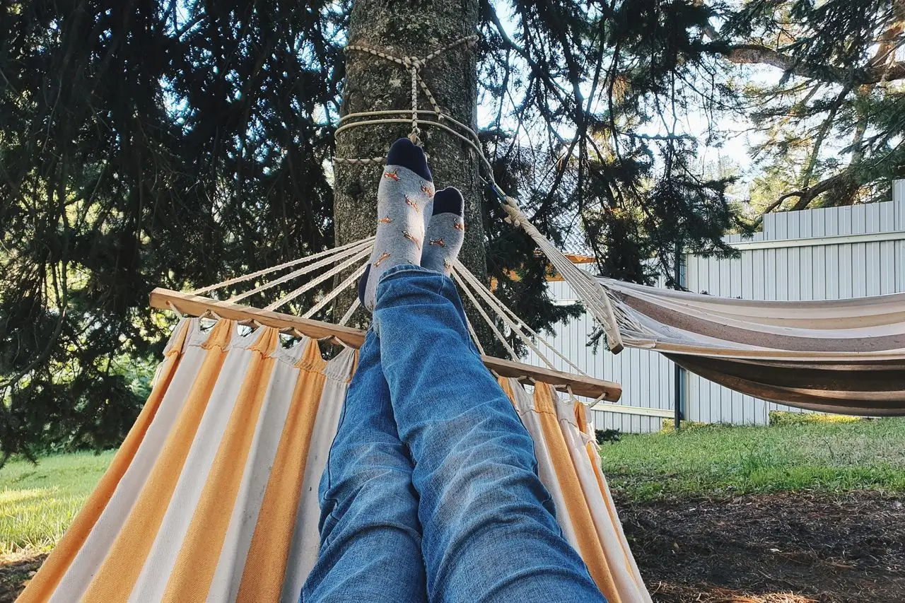 Person resting peacefully in summer light, representing recovery from summer burnout with therapy support in Vaughan