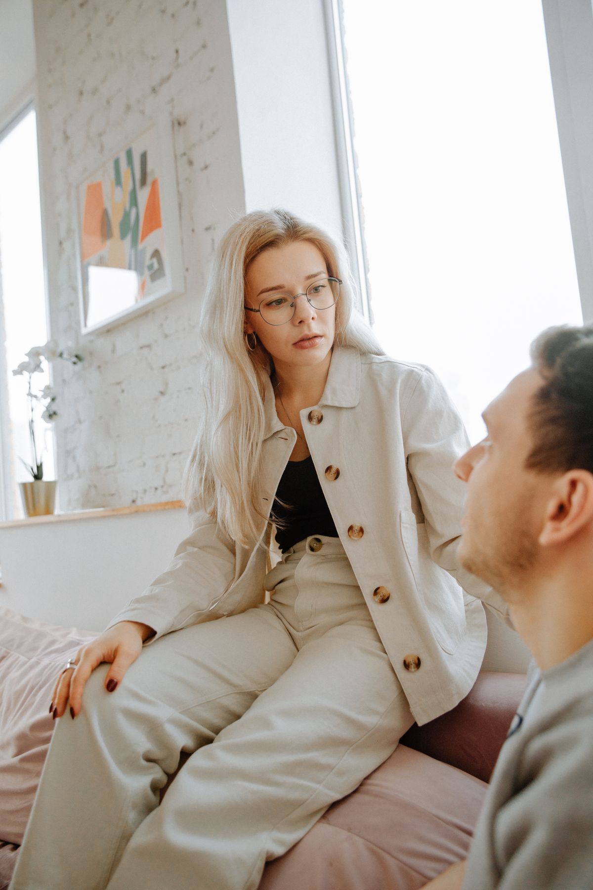 A couple sitting together in conversation in a bright room, representing Gottman Method couples therapy