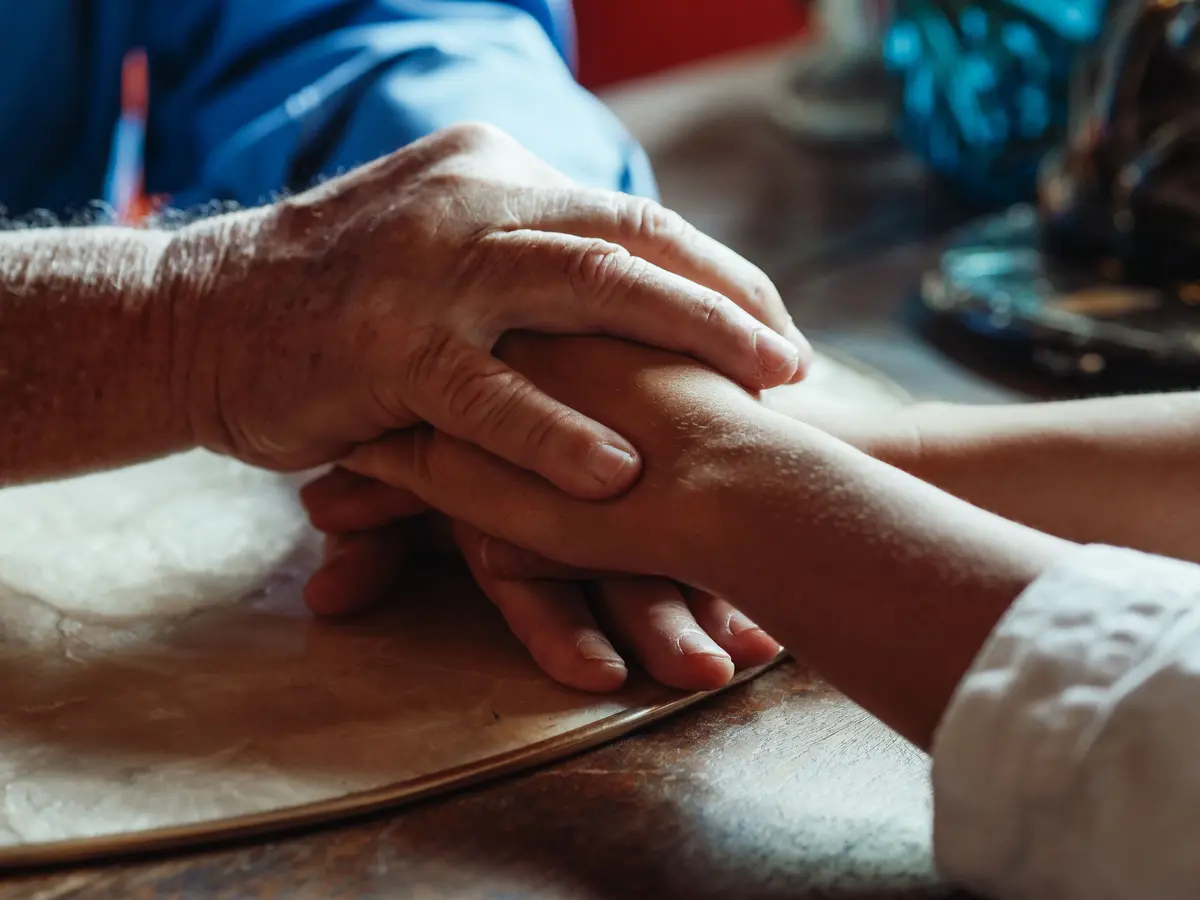Supportive hands in warm light, representing compassionate addiction counselling in Vaughan