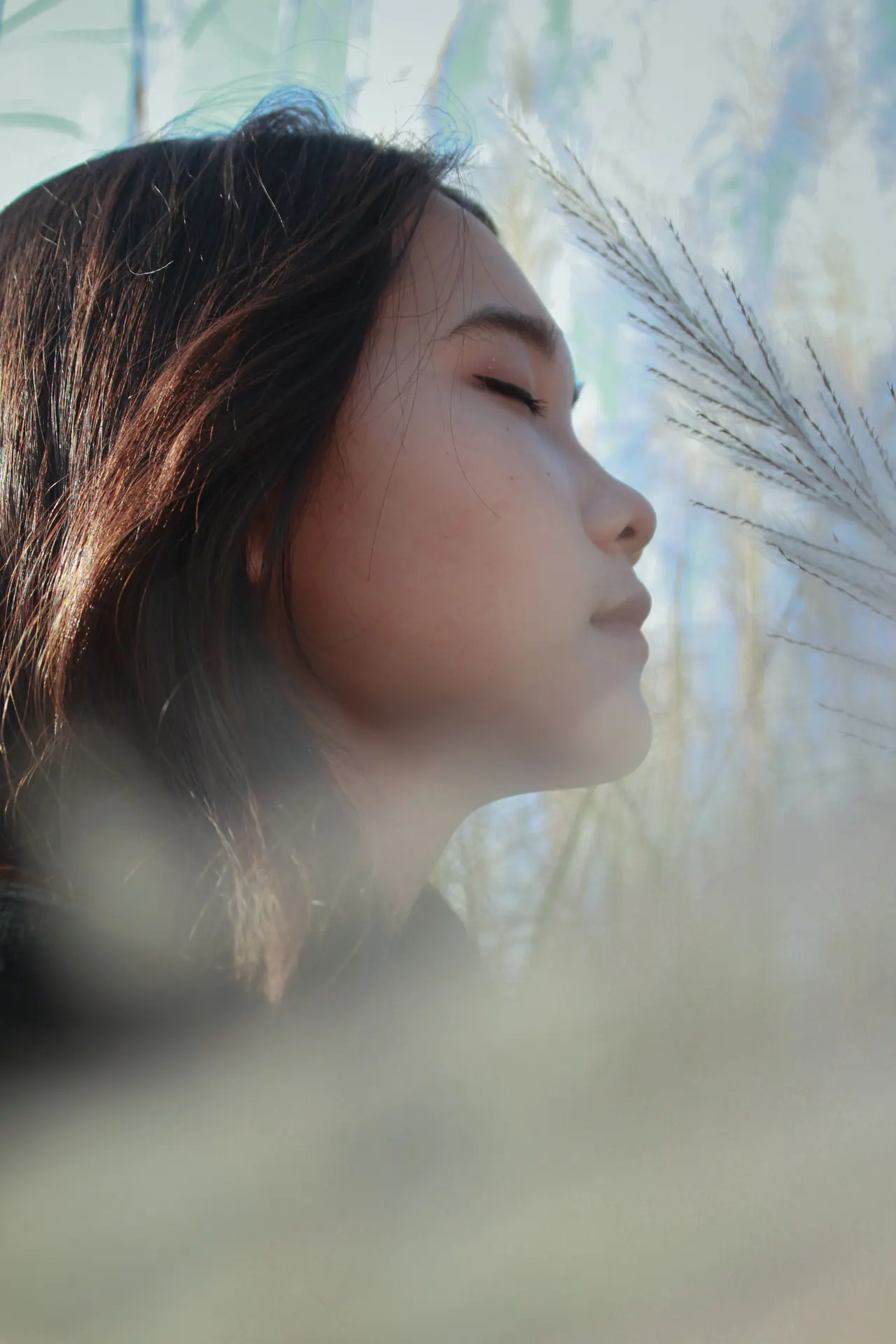 A woman with her eyes closed, calm in soft daylight