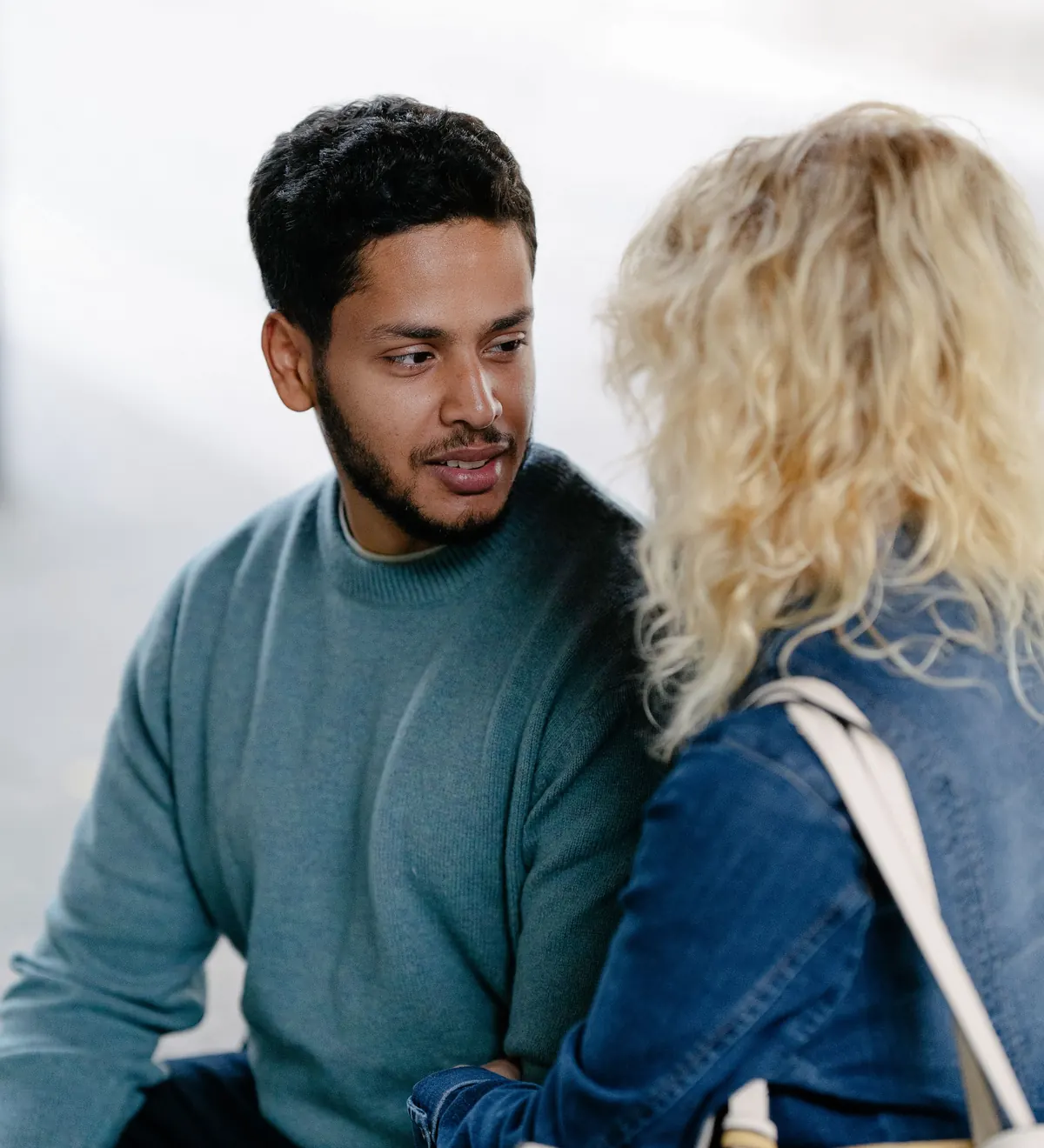 A couple sitting close together in conversation