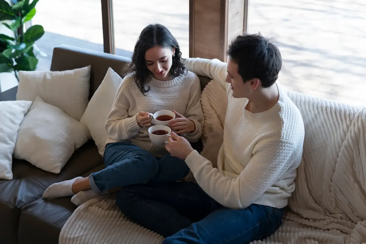 A couple sharing a relaxed moment together on the sofa
